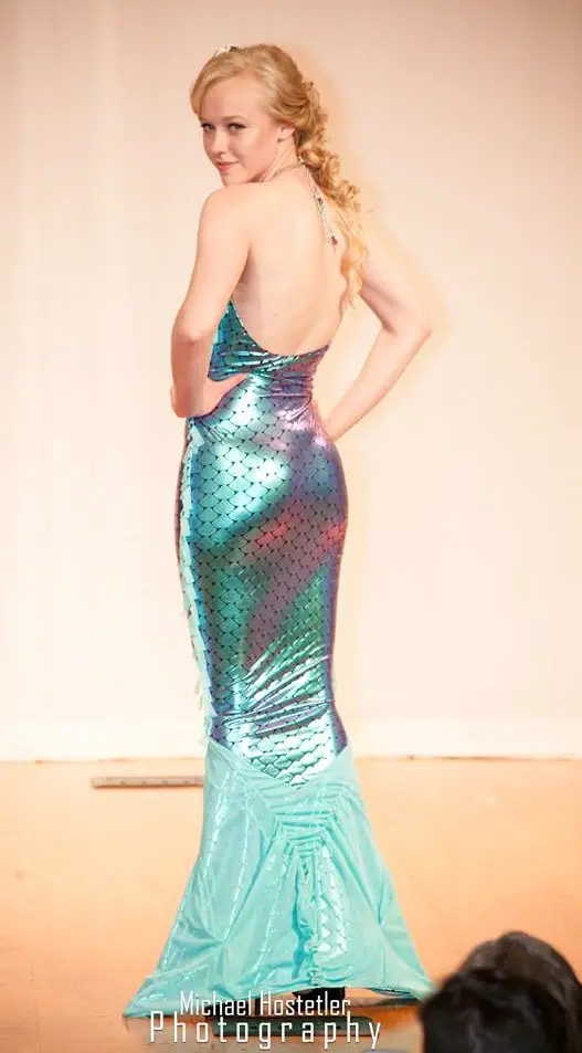 The back of the mermaid dress, where you can see the crystal drops hanging down from the necklace, the fringe in the side seams, and the gathers and ruching that were sewn into the tulle to add texture and visual interest to the design of the fin. Fashion design can be exhausting sometimes. ;-)