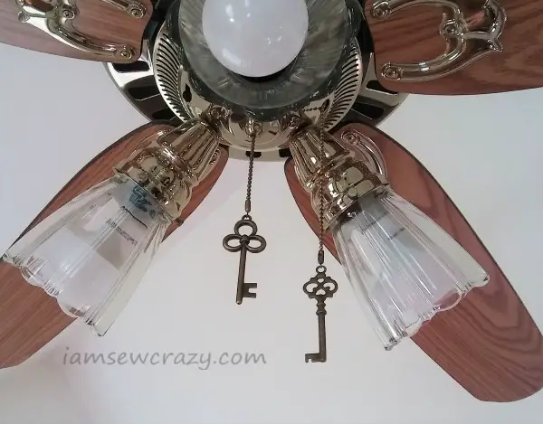 skeleton keys hanging from a ceiling fan