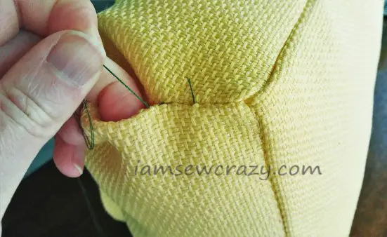 closing the opening of the pillow with hand stitches