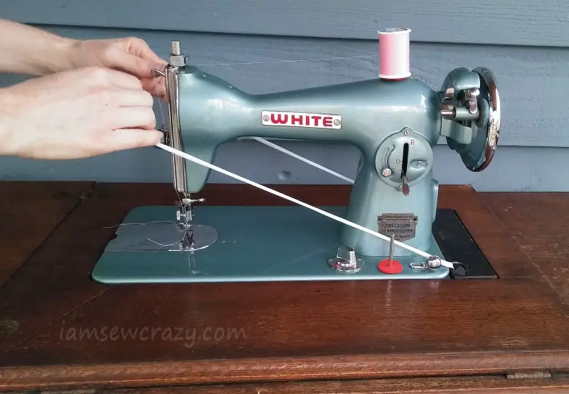 stretching a treadle belt over the machine