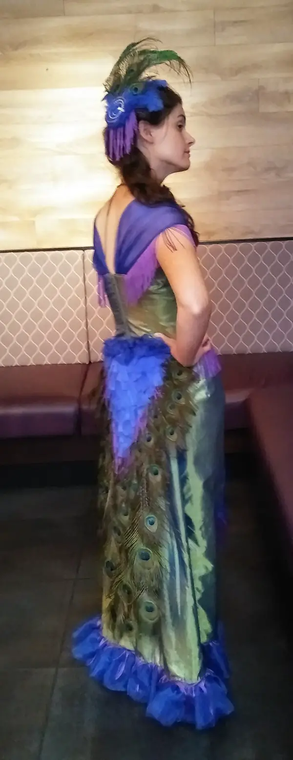 woman wearing victorian peacock dress
