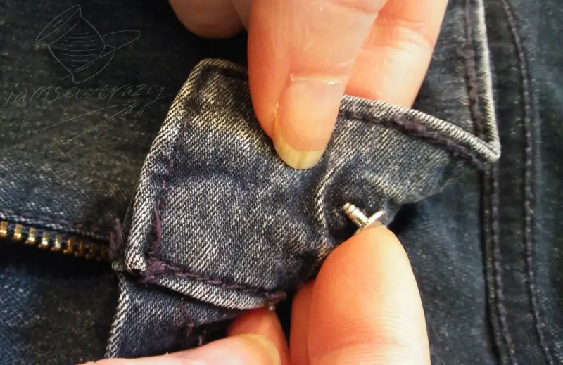 putting new button tack on jeans
