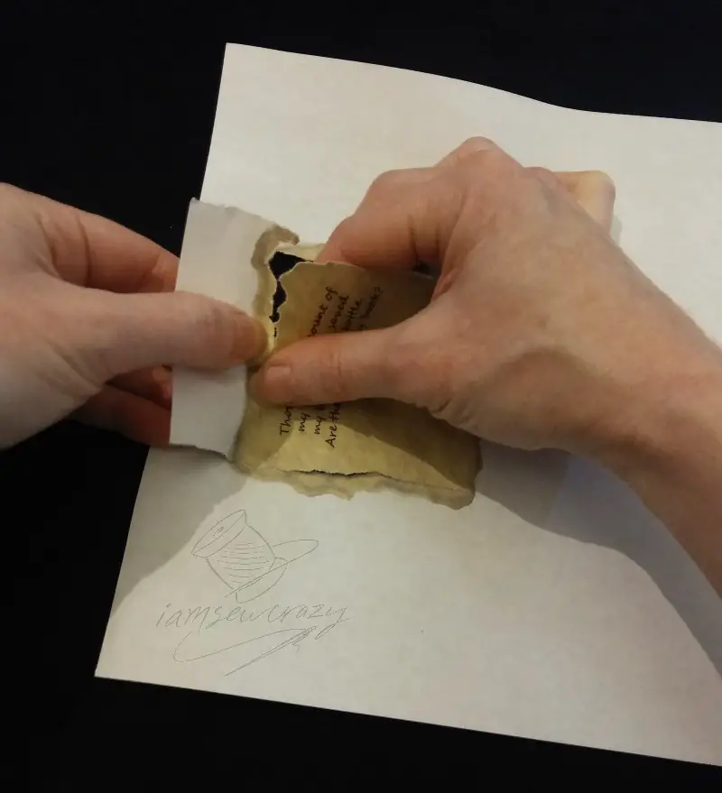 tearing scroll out of paper