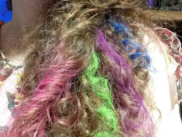 pink, green, purple, and blue hair chalk in curly red hair