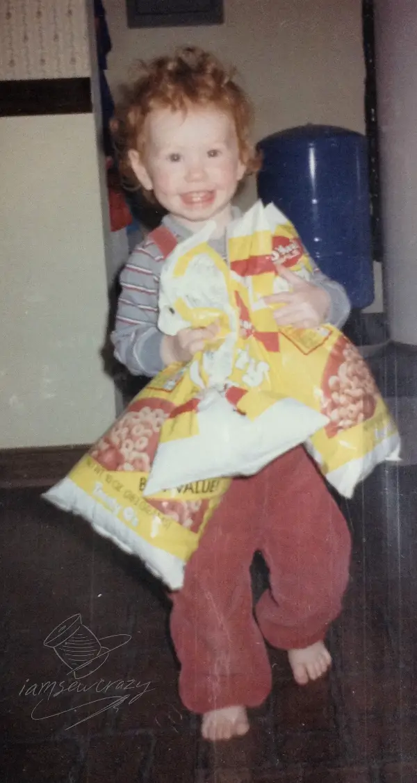 small child holding bags of cereal