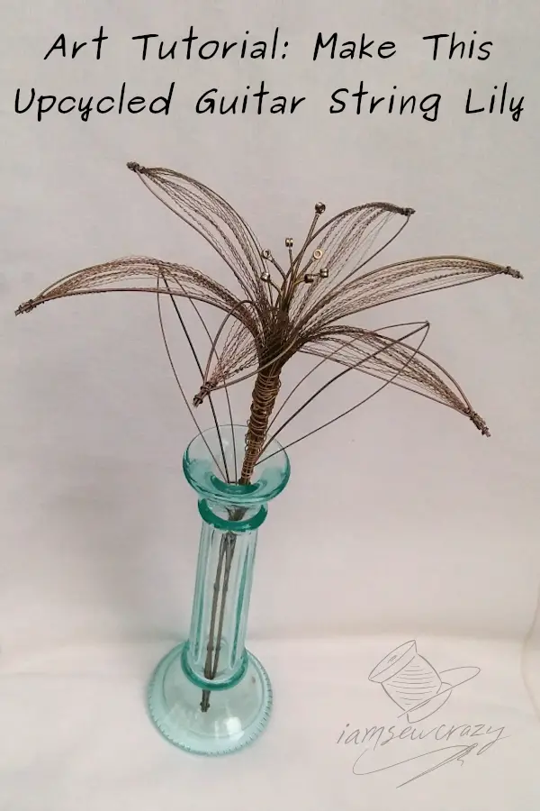 guitar string flower sculpture with text overlay: art tutorial: make this upcycled guitar string lily