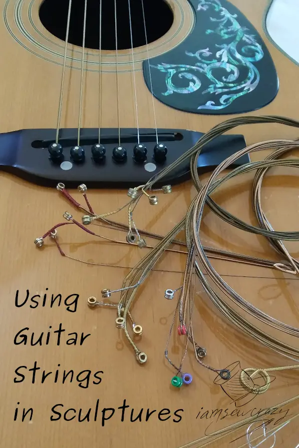 guitar body with abalone decal and text overlay: using guitar strings in sculptures