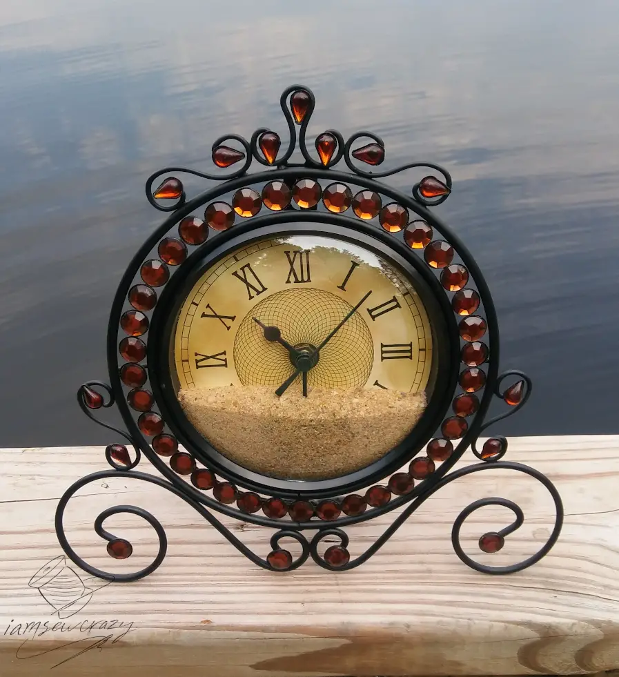 clock filled with sand sitting on dock