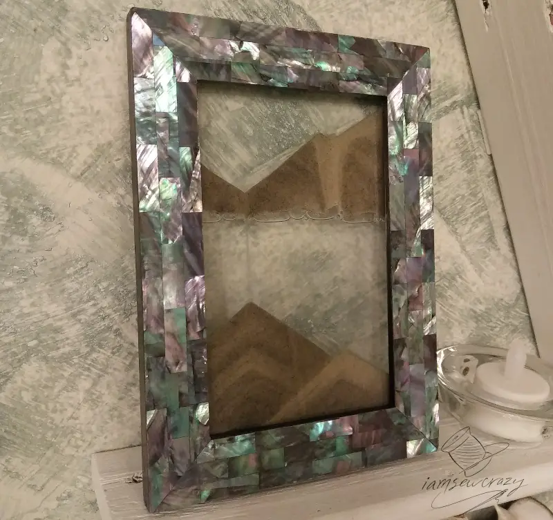 abalone picture frame with sand slowly falling between glass panels