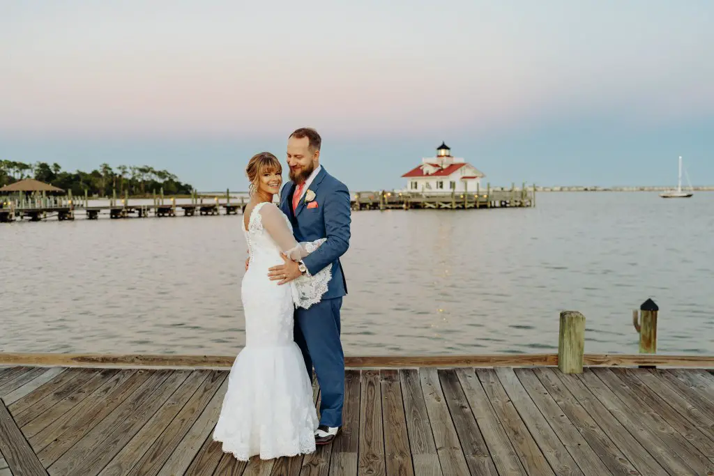 bride and groom posing on dock