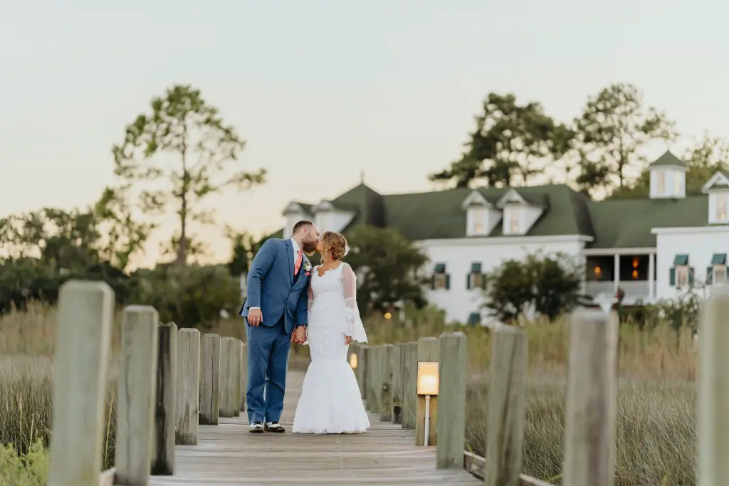 bride and groom walking down pier