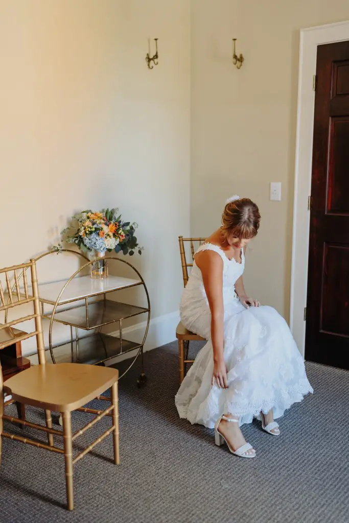 bride putting on shoes for a wedding