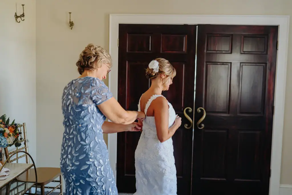bride getting ready for wedding wearing her mother's restyled wedding dress