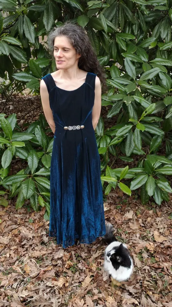 lady in dress posing with cat posing in front of her