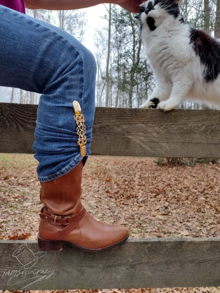 boot resting on fence rail