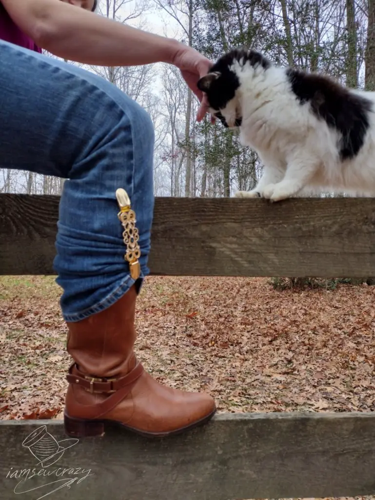 boot resting on fence rail