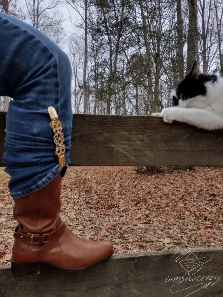 boot resting on fence rail