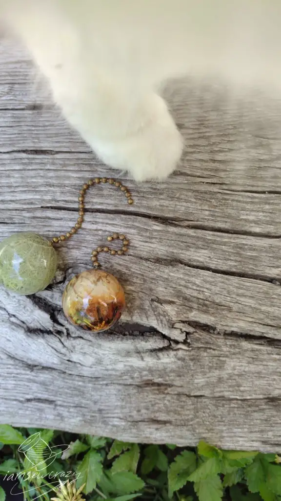 pictures of resin chain pulls with paw appearing in frame