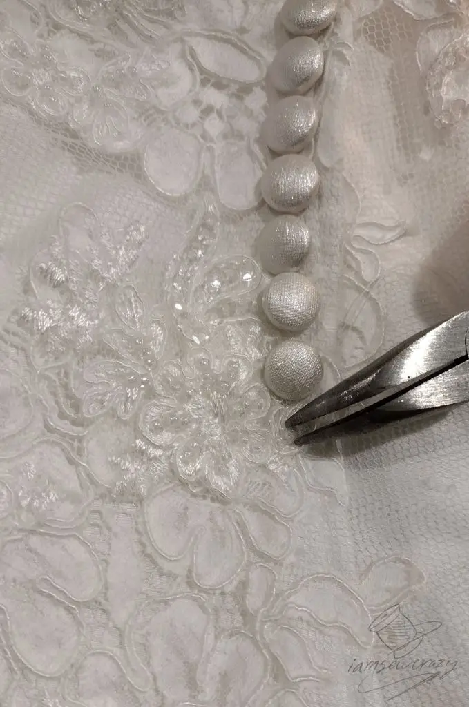 using pliers to crush glass bead that was sewn to lace applique