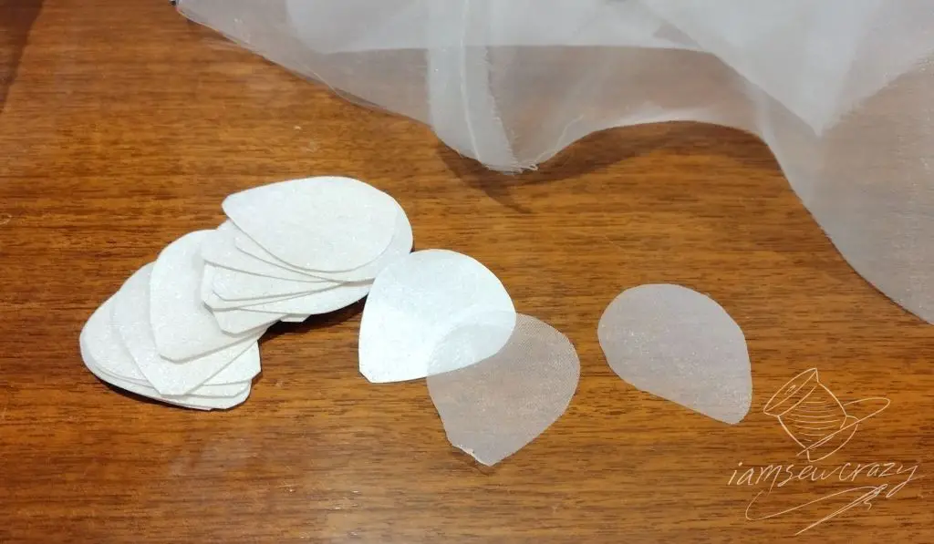 pieces of fabric cut out to make flower-shaped bridal fascinator