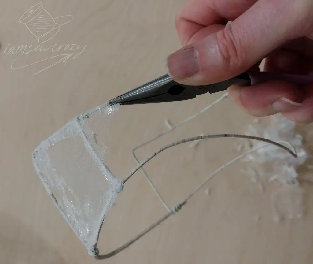 removing tulle from the frame of a vintage wedding veil