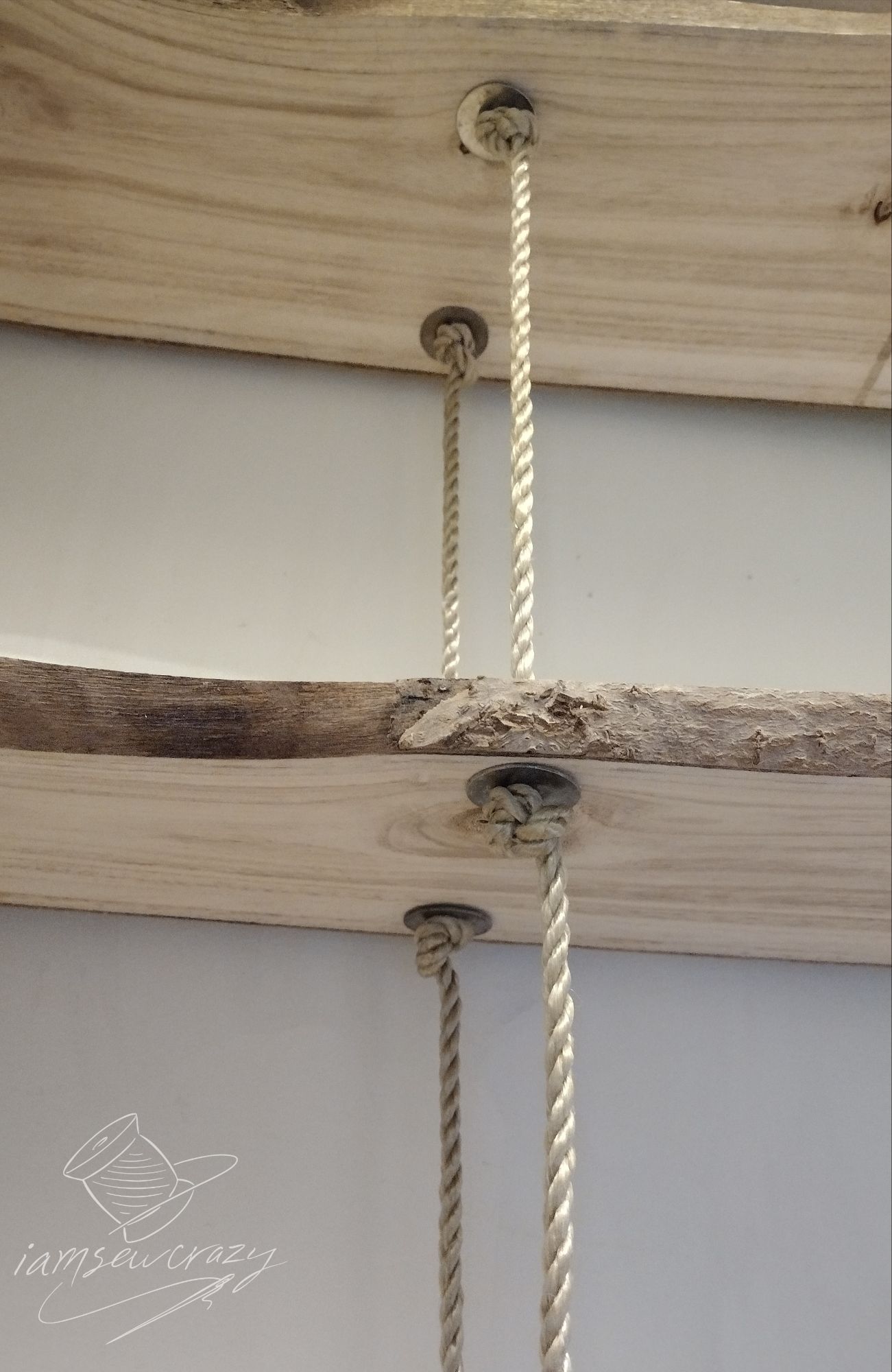 shelves that hang from ropes being supported by washers and knots in the ropes