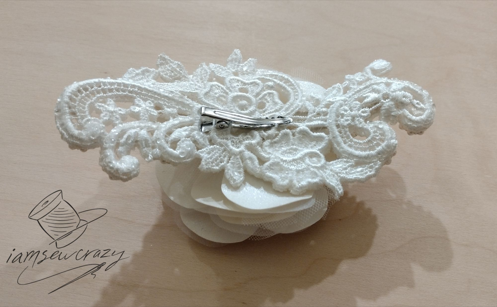 alligator clip on the back of a bridal fascinator to attach it to the bride's hair