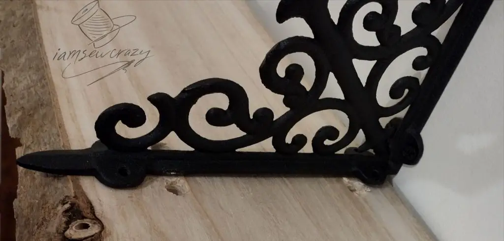 bolting a wooden shelf to cast iron brackets to make shelves that hang from ropes