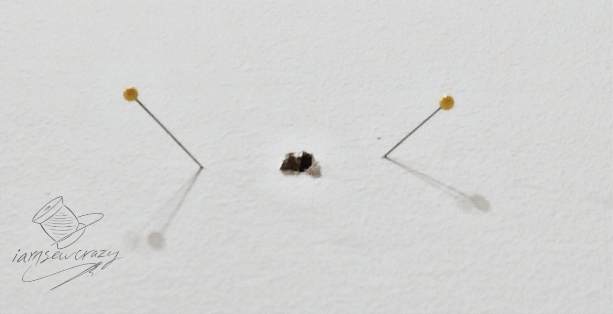 checking location of wall studs by sticking straight pins into the drywall