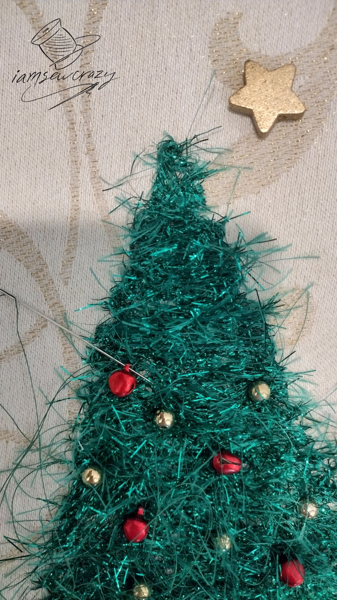 adding beads and bells to a couched christmas tree