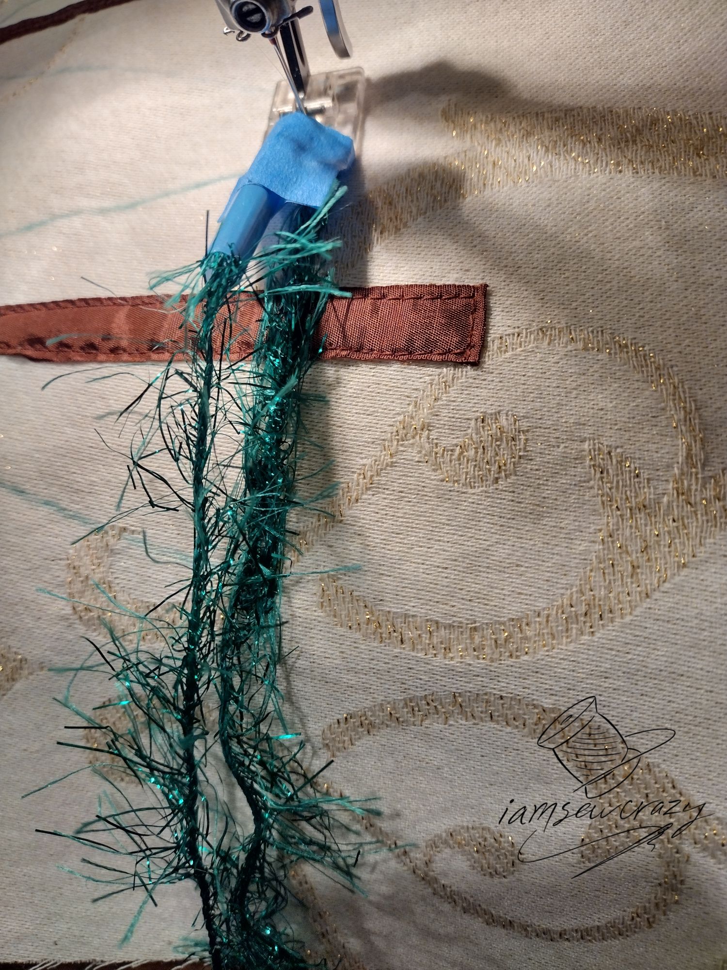 sewing over green eyelash yarn to create christmas tree branches