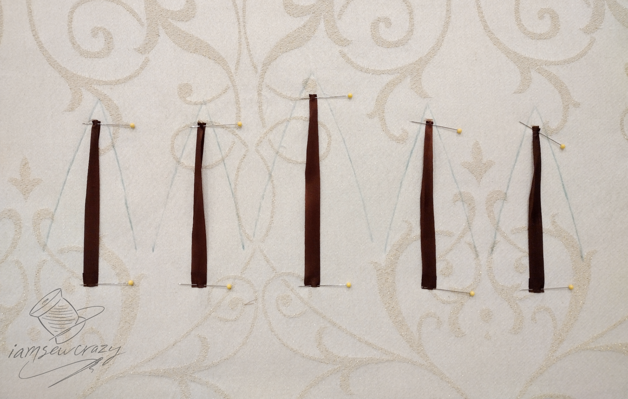 brown ribbon pinned to pillows to make christmas tree trunks